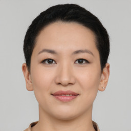 Joyful asian young-adult female with short  black hair and brown eyes