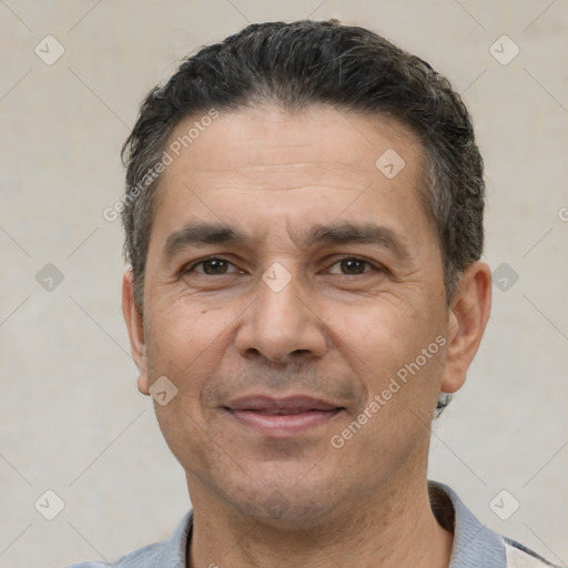 Joyful white adult male with short  black hair and brown eyes