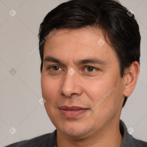 Joyful white adult male with short  brown hair and brown eyes