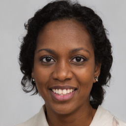 Joyful black young-adult female with medium  brown hair and brown eyes