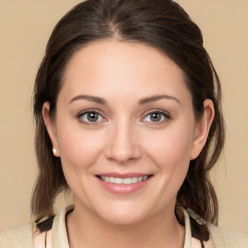 Joyful white young-adult female with medium  brown hair and brown eyes