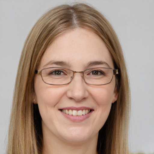 Joyful white adult female with long  brown hair and green eyes