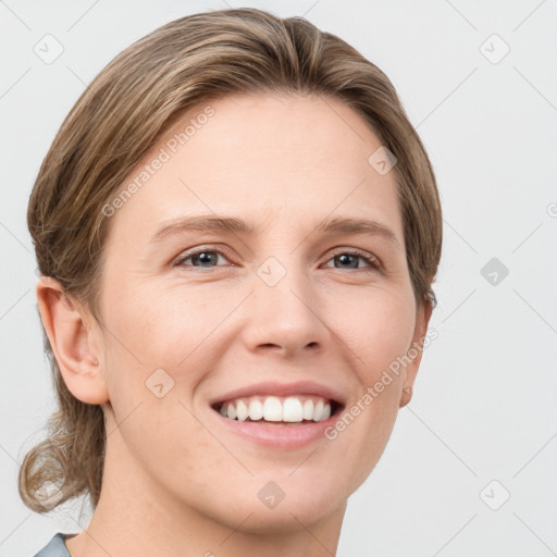 Joyful white young-adult female with short  brown hair and grey eyes