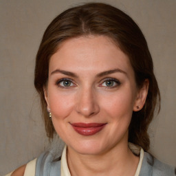 Joyful white young-adult female with medium  brown hair and blue eyes