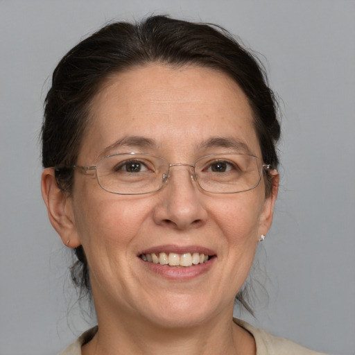 Joyful white adult female with medium  brown hair and blue eyes