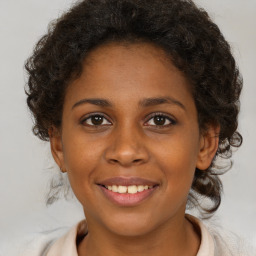 Joyful black young-adult female with medium  brown hair and brown eyes