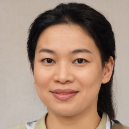 Joyful asian young-adult female with medium  brown hair and brown eyes