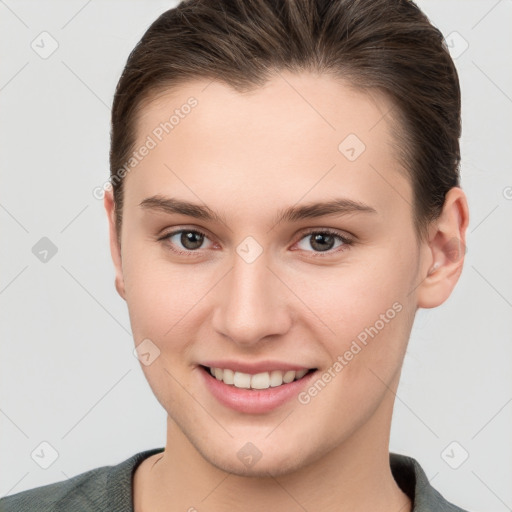 Joyful white young-adult female with short  brown hair and brown eyes