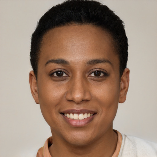 Joyful black young-adult female with short  black hair and brown eyes