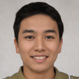 Joyful asian young-adult male with short  brown hair and brown eyes