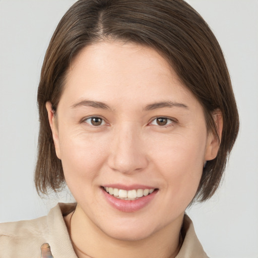 Joyful white young-adult female with medium  brown hair and brown eyes