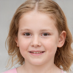 Joyful white child female with medium  brown hair and brown eyes