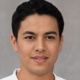 Joyful latino young-adult male with short  brown hair and brown eyes