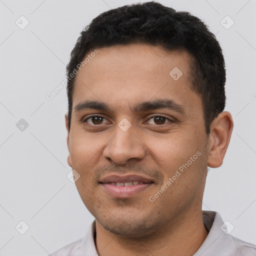 Joyful latino young-adult male with short  black hair and brown eyes