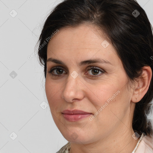 Joyful white adult female with medium  brown hair and brown eyes