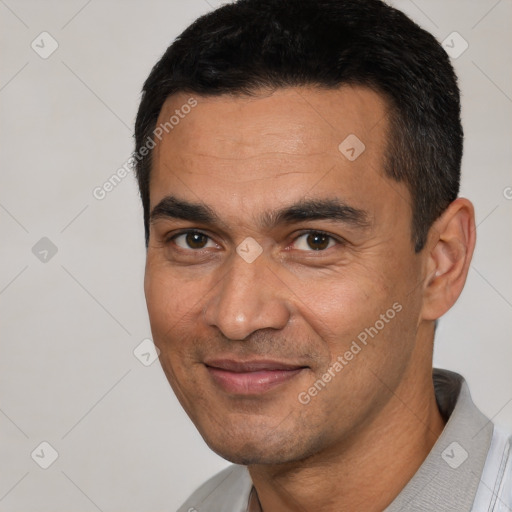 Joyful white young-adult male with short  black hair and brown eyes