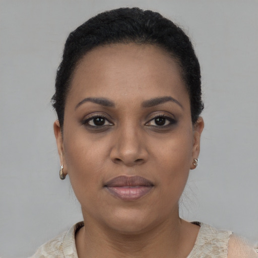 Joyful black young-adult female with short  brown hair and brown eyes