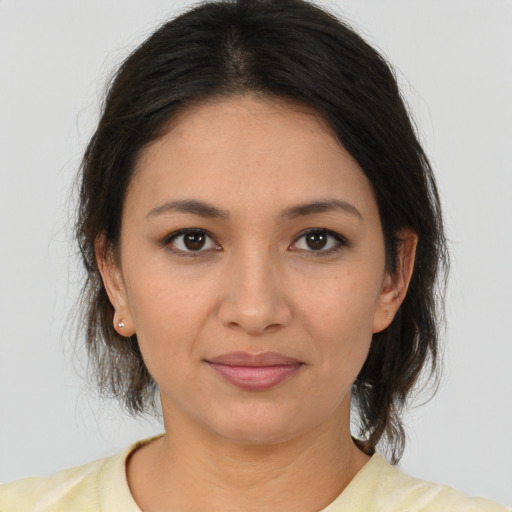 Joyful latino young-adult female with medium  brown hair and brown eyes
