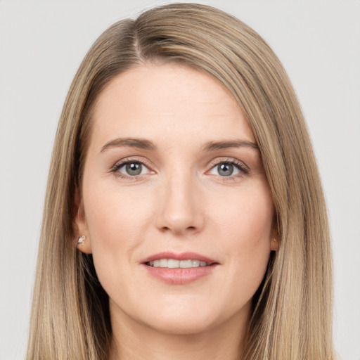 Joyful white young-adult female with long  brown hair and grey eyes