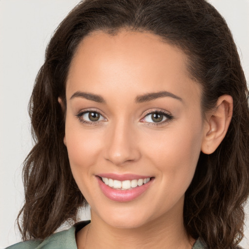 Joyful white young-adult female with long  brown hair and brown eyes