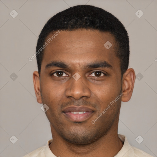 Joyful black young-adult male with short  black hair and brown eyes