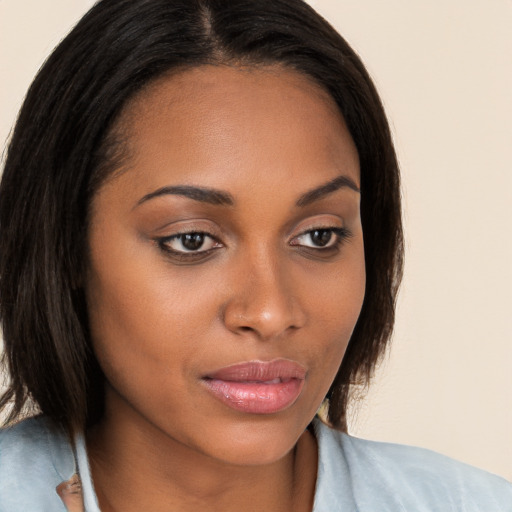 Joyful black young-adult female with medium  brown hair and brown eyes