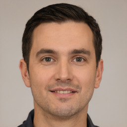 Joyful white young-adult male with short  brown hair and brown eyes