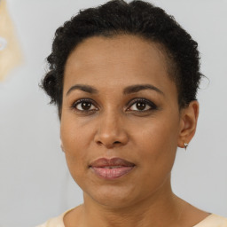 Joyful black adult female with short  brown hair and brown eyes