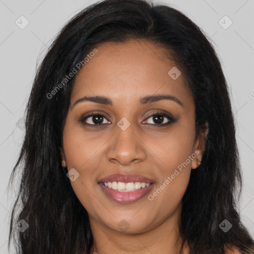 Joyful black young-adult female with long  brown hair and brown eyes