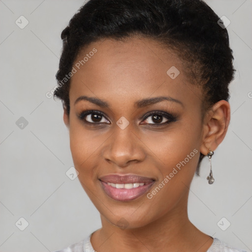 Joyful black young-adult female with short  brown hair and brown eyes