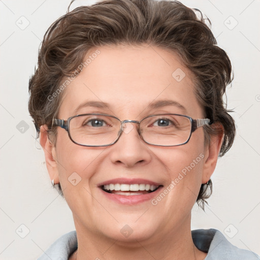 Joyful white adult female with medium  brown hair and blue eyes