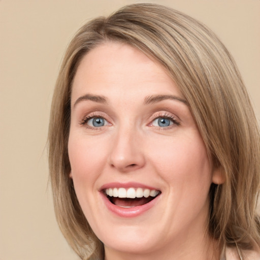 Joyful white young-adult female with medium  brown hair and blue eyes