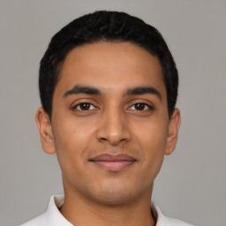 Joyful latino young-adult male with short  black hair and brown eyes