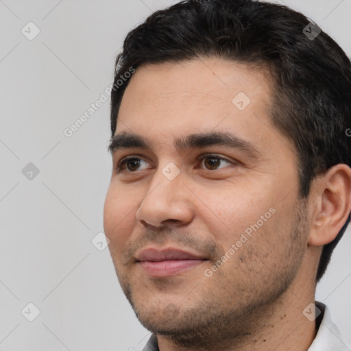 Joyful white young-adult male with short  black hair and brown eyes