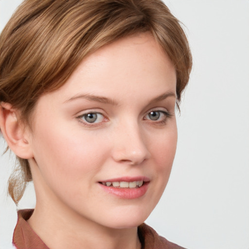 Joyful white young-adult female with long  brown hair and blue eyes