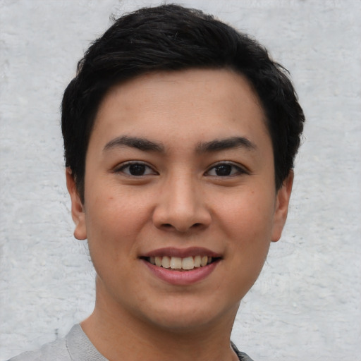 Joyful asian young-adult female with short  black hair and brown eyes