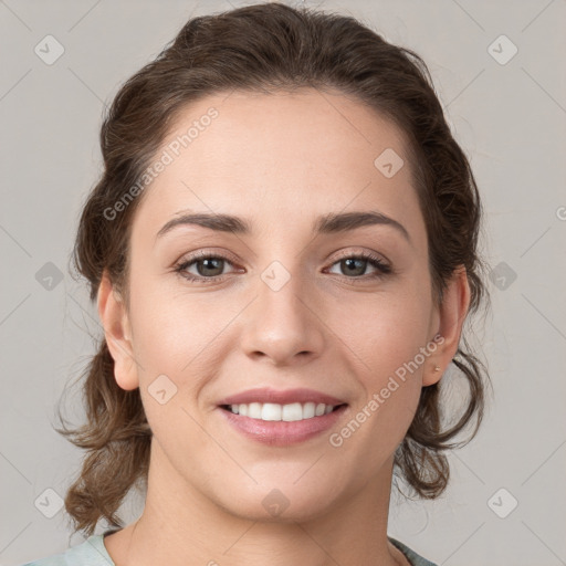 Joyful white young-adult female with medium  brown hair and grey eyes