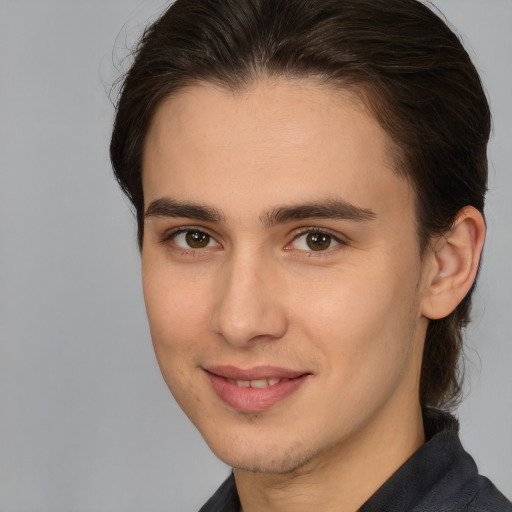 Joyful white young-adult male with medium  brown hair and brown eyes