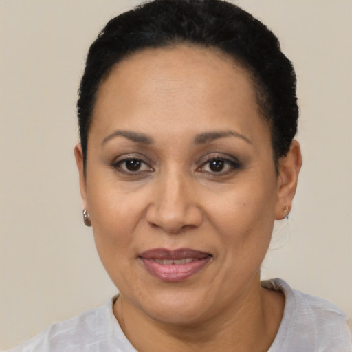 Joyful latino adult female with short  black hair and brown eyes