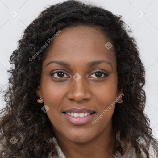 Joyful black young-adult female with long  brown hair and brown eyes