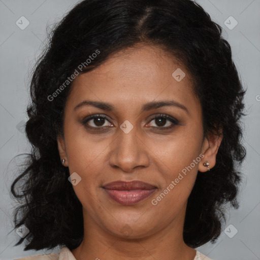 Joyful black adult female with long  brown hair and brown eyes