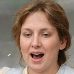 Joyful white adult female with medium  brown hair and blue eyes