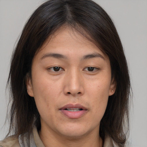 Joyful asian young-adult female with medium  brown hair and brown eyes