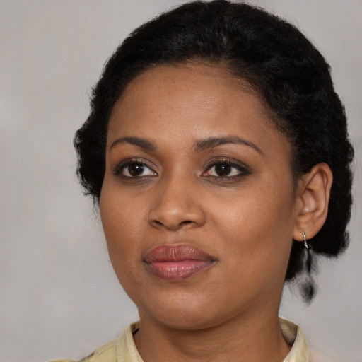 Joyful black young-adult female with medium  black hair and brown eyes