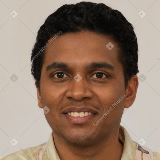 Joyful black young-adult male with short  black hair and brown eyes