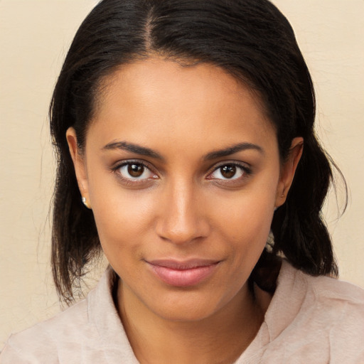 Joyful black young-adult female with medium  brown hair and brown eyes