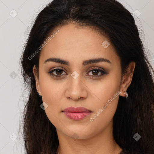 Joyful latino young-adult female with long  brown hair and brown eyes