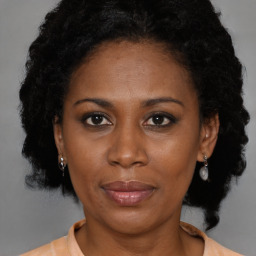 Joyful black adult female with medium  brown hair and brown eyes