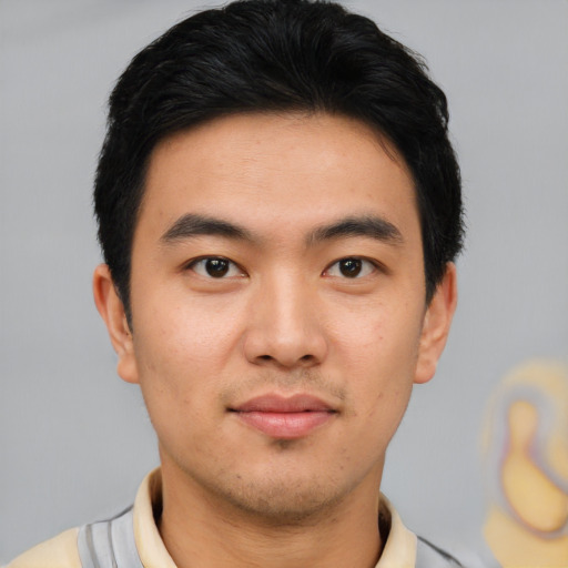Joyful asian young-adult male with short  black hair and brown eyes
