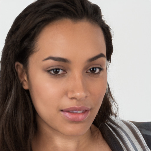 Joyful latino young-adult female with long  brown hair and brown eyes